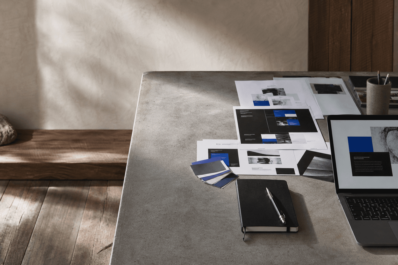 Website layouts and design materials arranged on a studio worktable